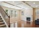 Cozy living room with fireplace, coffered ceiling, hardwood floors, and lots of natural light at 2638 Lake Manor Cir, Duluth, GA 30096
