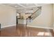 Open-concept living room featuring hardwood floors and coffered ceiling; kitchen is visible in the background at 2638 Lake Manor Cir, Duluth, GA 30096