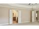 View from primary bedroom showing double doors leading to the primary bath with neutral tile flooring at 2638 Lake Manor Cir, Duluth, GA 30096