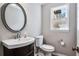 Small bathroom features a dark vanity, large mirror, and window letting in natural light at 2771 Kenwood Dr, Duluth, GA 30096