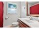 Small bathroom features a white sink and toilet plus a window and red curtain at 2771 Kenwood Dr, Duluth, GA 30096