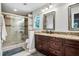 Bathroom features a dual vanity with granite counters and a glass-enclosed shower at 2771 Kenwood Dr, Duluth, GA 30096