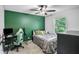 Bright bedroom with an accent wall, ceiling fan, and a comfortable bed near a window at 2771 Kenwood Dr, Duluth, GA 30096