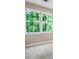 Bedroom with large windows providing a view of leafy green trees at 2771 Kenwood Dr, Duluth, GA 30096