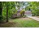 Charming two-story brick home with a well-manicured lawn and mature trees offering curb appeal at 2771 Kenwood Dr, Duluth, GA 30096