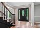 Foyer with hardwood floors, staircase, black door, and decorative glass inserts at 2771 Kenwood Dr, Duluth, GA 30096