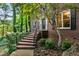 Brick home entrance featuring a decorative door, black shutters, and landscaped walkway at 2771 Kenwood Dr, Duluth, GA 30096