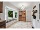 Bright kitchen features a tile floor, bay window with bench, and wooden built-in cabinet at 2771 Kenwood Dr, Duluth, GA 30096