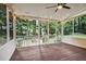 Relaxing screened porch with wood flooring, string lights, and views of the outdoor area at 2771 Kenwood Dr, Duluth, GA 30096