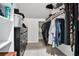 Walk-in closet with shelving, clothes racks, and a view into the bathroom at 2771 Kenwood Dr, Duluth, GA 30096
