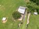 Aerial view of property including barn, stables, and green pastures at 3905 Pointer Rd, Loganville, GA 30052