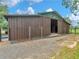 Expansive barn featuring a large open sliding door and ample space for storage at 3905 Pointer Rd, Loganville, GA 30052