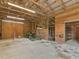 Spacious barn interior with tractor and mower storage, featuring wooden walls and a concrete floor at 3905 Pointer Rd, Loganville, GA 30052