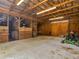 Spacious barn interior featuring wooden stalls, metal roof, and ample room for storage and equipment at 3905 Pointer Rd, Loganville, GA 30052