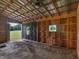 Well ventilated barn featuring an open entrance, windows, ceiling fan, and a gravel floor at 3905 Pointer Rd, Loganville, GA 30052