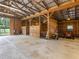 Large barn interior showcasing multiple horse stalls, ample open space, and high ceilings at 3905 Pointer Rd, Loganville, GA 30052