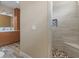 Modern bathroom featuring a tiled shower with a built-in bench and a stone-tiled floor at 3905 Pointer Rd, Loganville, GA 30052