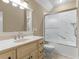 Bathroom featuring tile flooring, vanity, a sink, and a shower-tub combo with a sliding glass door at 3905 Pointer Rd, Loganville, GA 30052