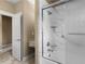 Bathroom featuring a tub with a marble tile surround, offering a luxurious space to relax at 3905 Pointer Rd, Loganville, GA 30052