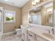 Elegant bathroom featuring a double vanity, tile floors, and natural light from the window at 3905 Pointer Rd, Loganville, GA 30052