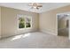 Cozy bedroom with neutral tones, plush carpeting, and a window providing ample natural light and a green outdoor view at 3905 Pointer Rd, Loganville, GA 30052