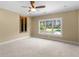 Spacious bedroom with neutral carpet, crown molding, and a scenic window view at 3905 Pointer Rd, Loganville, GA 30052