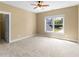 Bright bedroom with a ceiling fan and large window offering views of the outdoor scenery at 3905 Pointer Rd, Loganville, GA 30052