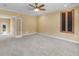 Spacious bedroom featuring neutral carpeting, a ceiling fan, and a window with natural light at 3905 Pointer Rd, Loganville, GA 30052