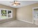 Carpeted bedroom featuring natural light, a ceiling fan, and an en suite bathroom with a glass-enclosed shower at 3905 Pointer Rd, Loganville, GA 30052
