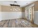 Dining room with a decorative light fixture and wainscoting at 3905 Pointer Rd, Loganville, GA 30052