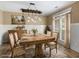 Bright dining room features a wood table set for six, stylish light fixture and wainscoting at 3905 Pointer Rd, Loganville, GA 30052