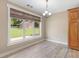 Bright dining area features wood-look floors, large window and chandelier lighting at 3905 Pointer Rd, Loganville, GA 30052