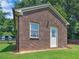 Charming brick building with white trim, set on a green lawn against a backdrop of trees at 3905 Pointer Rd, Loganville, GA 30052
