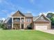 Beautiful two-story home featuring a manicured lawn, stone accents, and a welcoming front entrance at 3905 Pointer Rd, Loganville, GA 30052