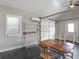 Well-lit space with a dining table, ceiling fan, mini-split unit, and garage door at 3905 Pointer Rd, Loganville, GA 30052