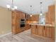 Kitchen with light-toned cabinets, stainless steel appliances, and wood-look tile flooring at 3905 Pointer Rd, Loganville, GA 30052