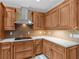 Kitchen with wood cabinets, stainless steel appliances, tile backsplash, and white countertops at 3905 Pointer Rd, Loganville, GA 30052