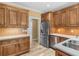 Kitchen with wood cabinets, stainless steel refrigerator, and tile backsplash at 3905 Pointer Rd, Loganville, GA 30052