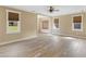 Open living room boasts wood-look floors, neutral walls and large windows for plenty of light at 3905 Pointer Rd, Loganville, GA 30052
