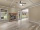 Living room with fireplace, coffered ceiling, wood-look tile flooring, and backyard view at 3905 Pointer Rd, Loganville, GA 30052