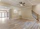Empty living room features coffered ceiling, wood-look tile flooring, and staircase at 3905 Pointer Rd, Loganville, GA 30052