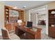 Office with built-in shelves and desk looking into dining area at 3905 Pointer Rd, Loganville, GA 30052