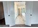 View into a bathroom with double doors, a soaking tub, marble tile, and glass enclosed shower at 500 Healy Dr # 77, Cumming, GA 30040