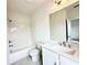 Bathroom with white tiled walls, tub, sink, and modern fixtures at 500 Healy Dr # 77, Cumming, GA 30040