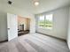Bright bedroom with neutral carpet, a large window overlooking the yard and an open door at 500 Healy Dr # 77, Cumming, GA 30040
