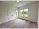 Bedroom with neutral carpet, closet, and bright windows overlooking the outdoors at 500 Healy Dr # 77, Cumming, GA 30040