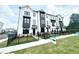 New townhome exterior with black framed windows, dark accents and black metal fencing at 500 Healy Dr # 77, Cumming, GA 30040