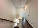 Hallway with wood floors, white walls, and staircase leading to the upper level at 500 Healy Dr # 77, Cumming, GA 30040