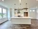 Bright kitchen with a large center island, stainless steel appliances, and contemporary lighting at 500 Healy Dr # 77, Cumming, GA 30040