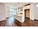 Modern kitchen featuring a central island, white cabinetry, and hardwood floors at 500 Healy Dr # 77, Cumming, GA 30040